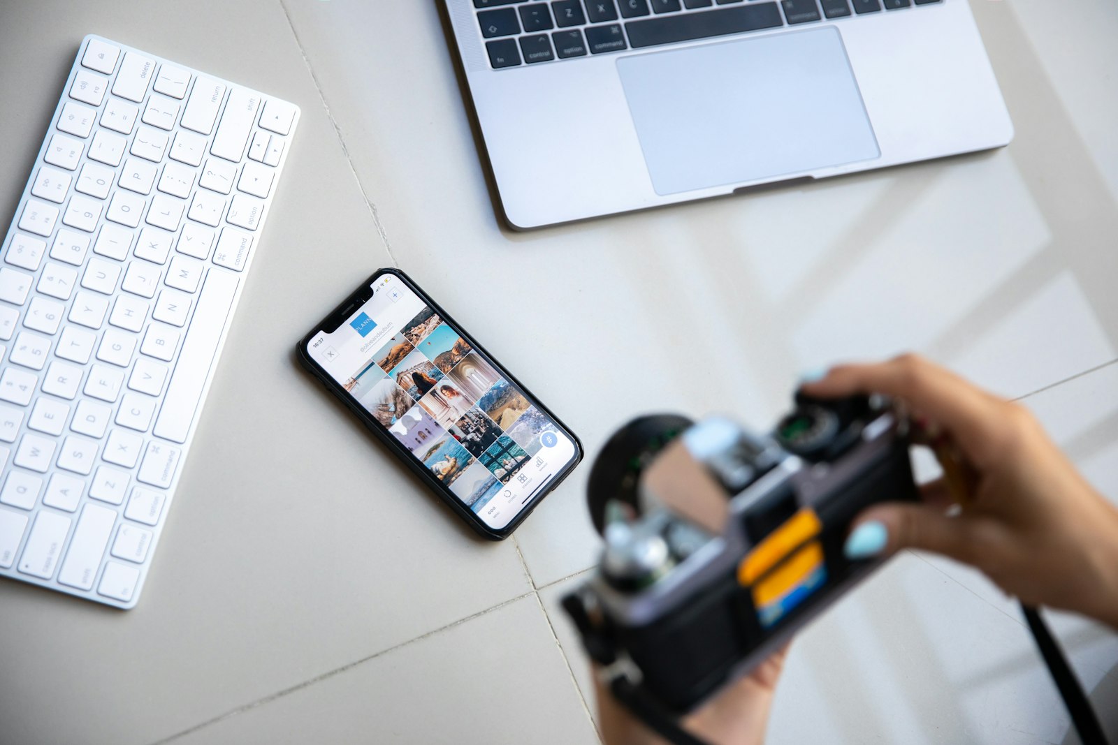 Phone resting on a laptop — a creator's workflow